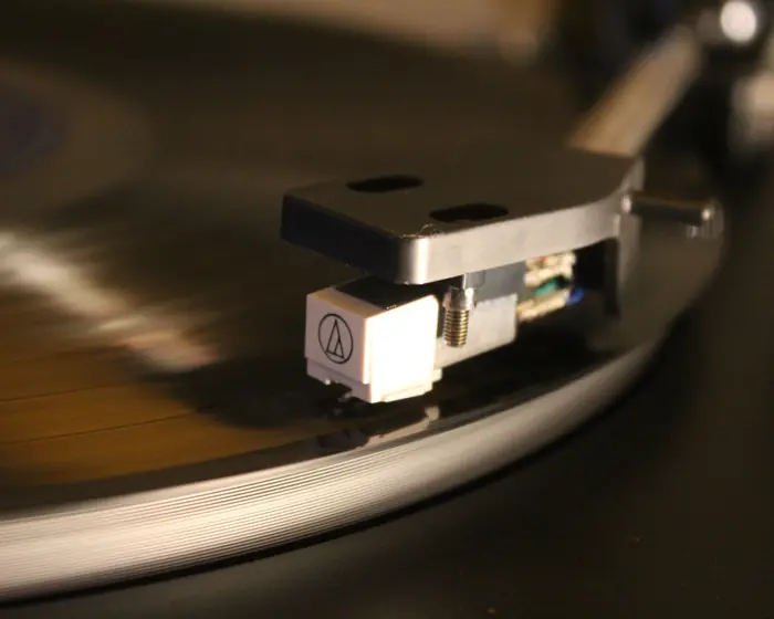 Turntable needle resting on a spinning vinyl record